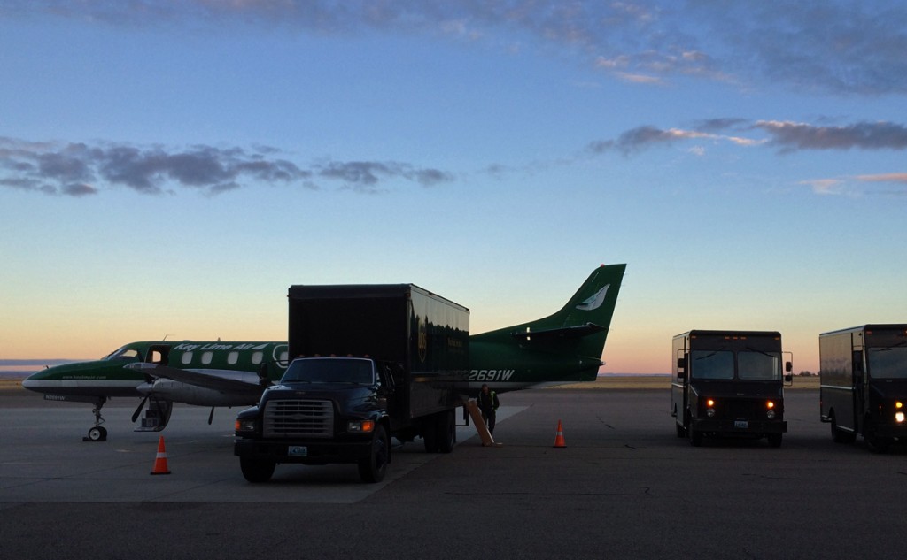 Unloading 3 trucks into twin engine airplane