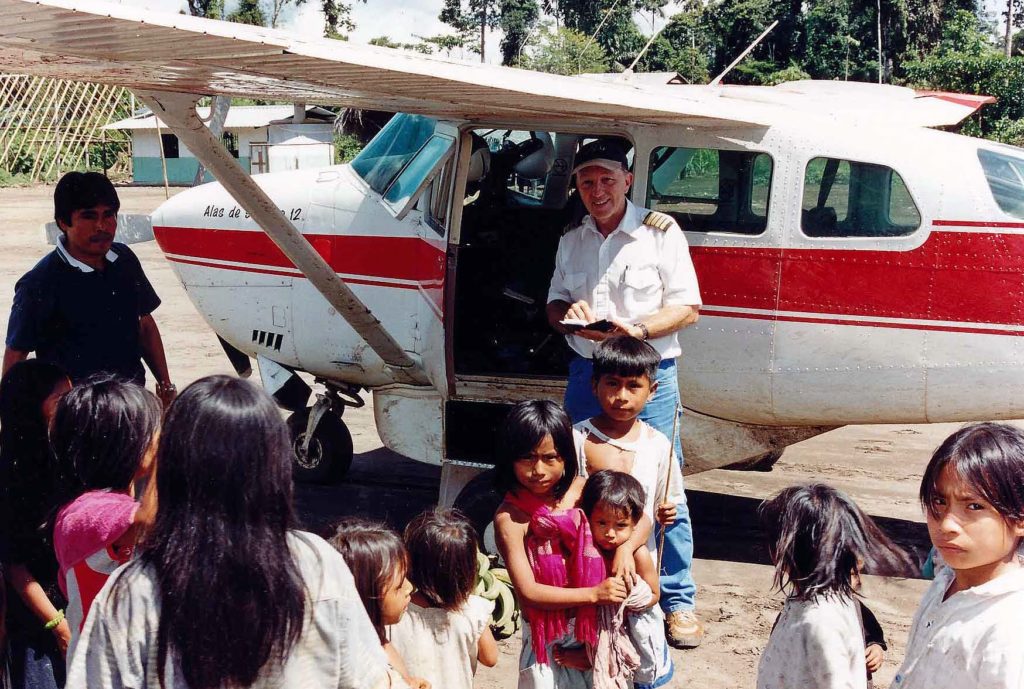 Jungle village kids and pilot at airplane