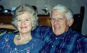 Gray haired couple sitting on a couch